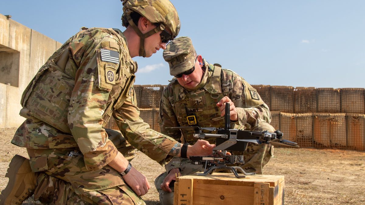 US Army soldier loads grenades onto a DEVCOM Armaments Center-designed drone chassis at Fort Bragg
