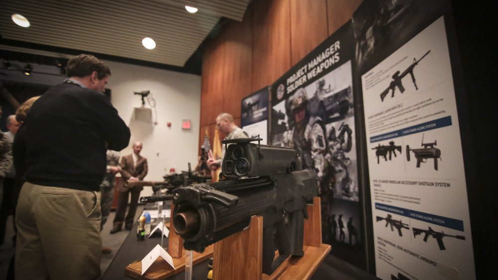 An XM25 Counter Defilade Target Engagement System on a display stand at Picatinny Arsenal
