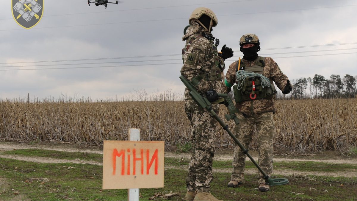 Ukrainian Support Forces personnel conducting mine-clearance operations with handheld detection equipment