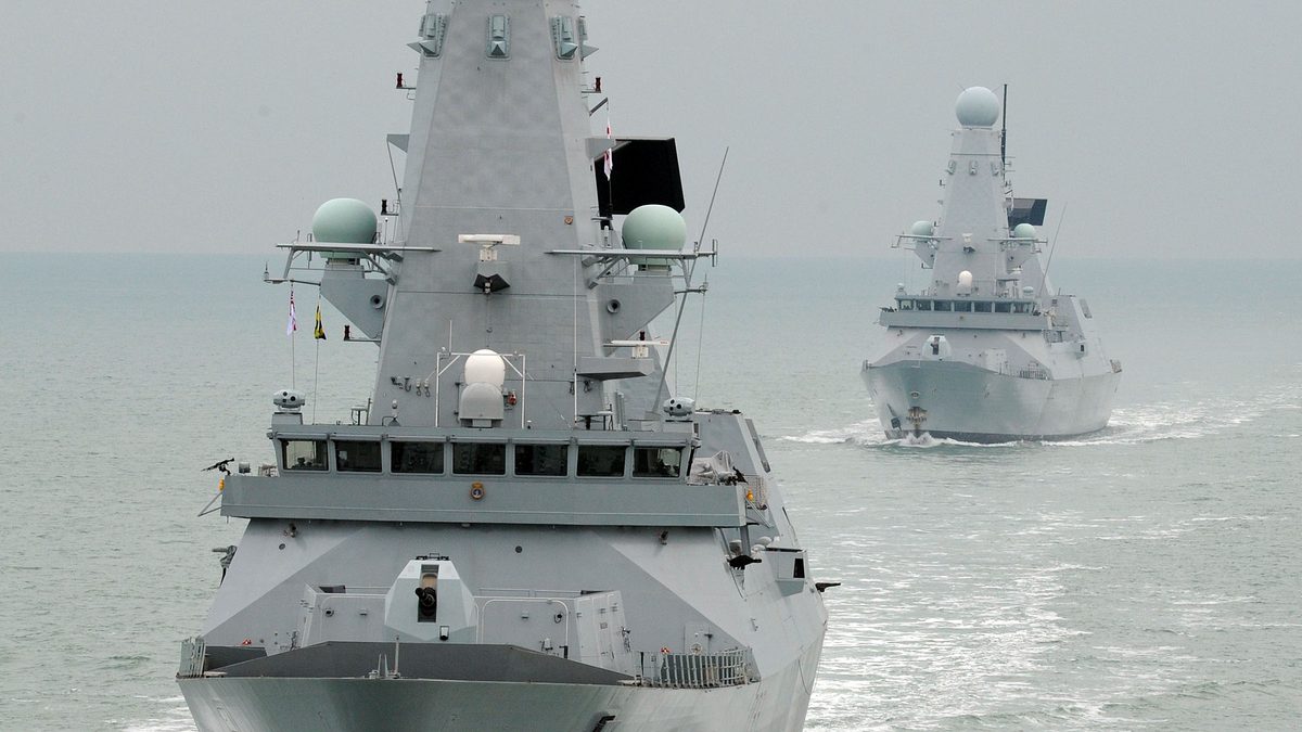 Type 45 destroyers HMS Daring and HMS Dauntless manoeuvring in close formation at sea south of the Isle of Wight