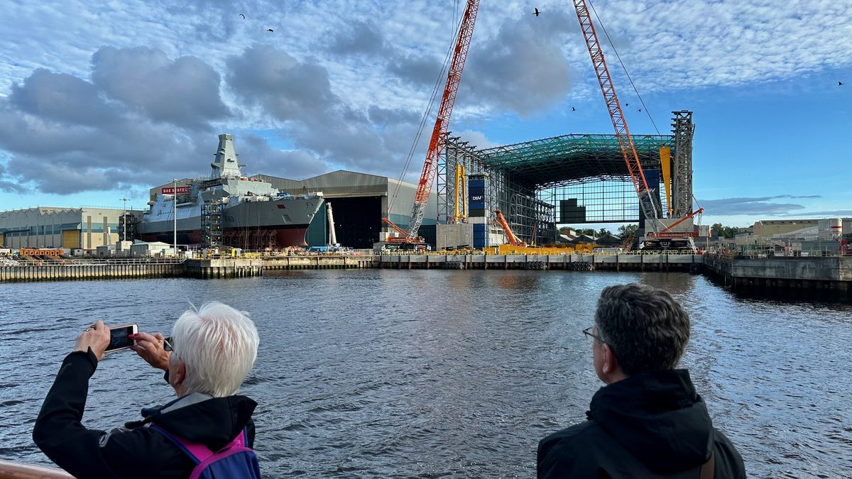 BAE Systems Govan shipyard in August 2024, showing HMS Cardiff F89, second of the Type 26 class, alongside the new Janet Harvey Hall frigate assembly facility under construction