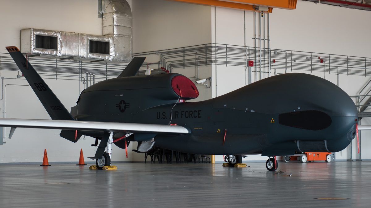 An RQ-4 Global Hawk sits in a hangar at Naval Air Station Sigonella, Italy, the operating base for NATO's NISRF RQ-4D Phoenix fleet