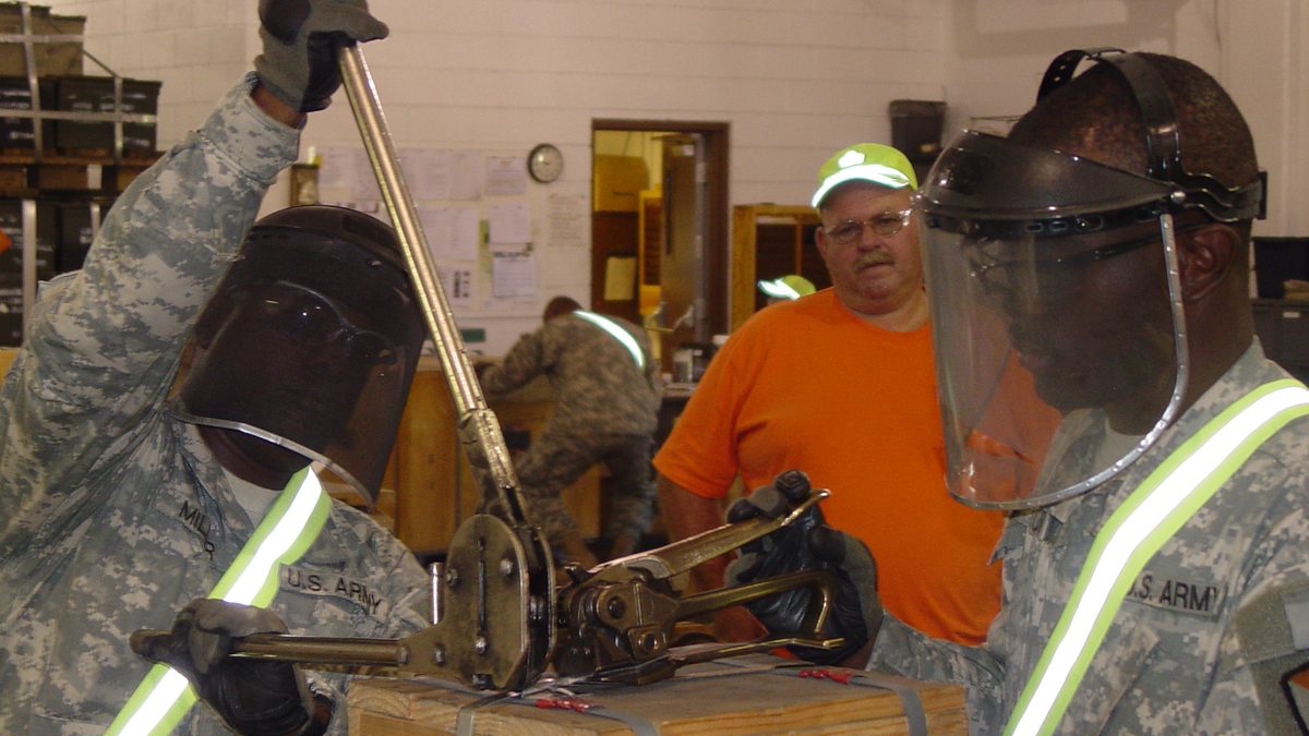 US Army Reservists banding a pallet of ammunition at Crane Army Ammunition Activity, illustrating ammunition stockpile management of the kind covered by NSPA Ammunition Support Partnership procurement notices.