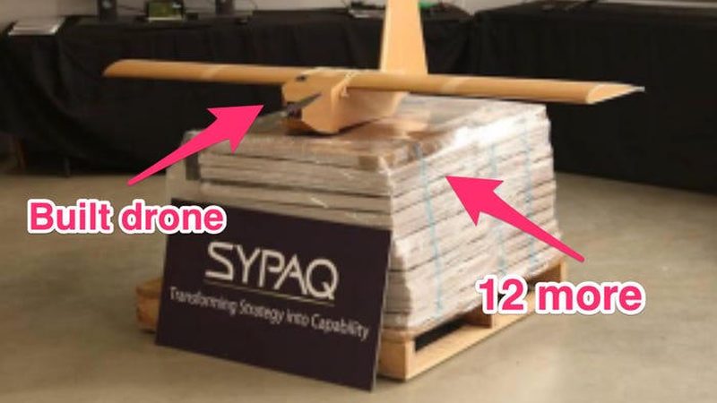 A single fully-assembled SYPAQ Corvo PPDS sits on top of a strapped pallet of twelve more flat-packed Corvo kits at the SYPAQ Systems workshop, Melbourne.