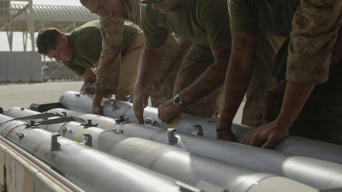 U.S. Marines handle an AIM-120 AMRAAM air-to-air missile
