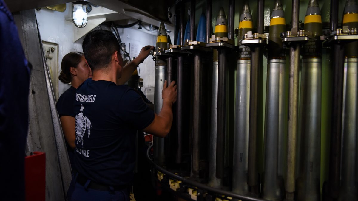 A US Coast Guard sailor loads 76mm rounds into the Mark 75 gun aboard USCGC Mohawk