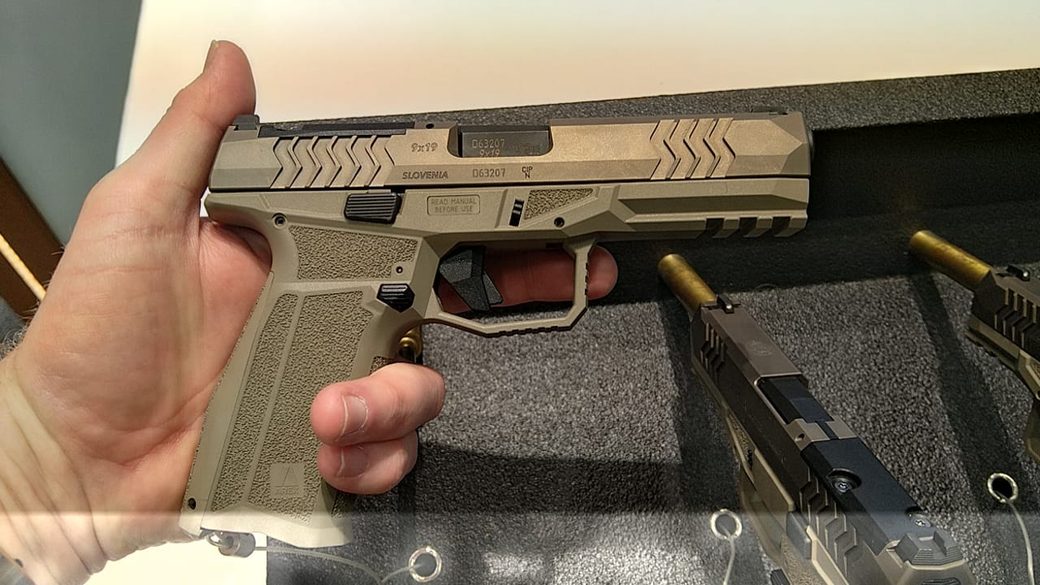 Full-size 9 mm pistol of the new Steyr line held on the Eurosatory stand, two more behind