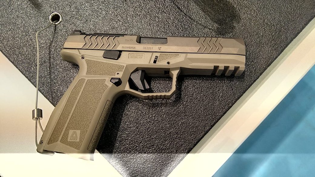 Top-down view of the full-size 9 mm pistol on the stand