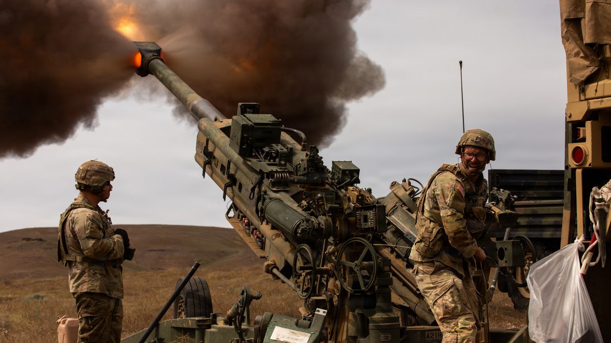 A US Army M777 towed 155mm howitzer firing during a live-fire exercise