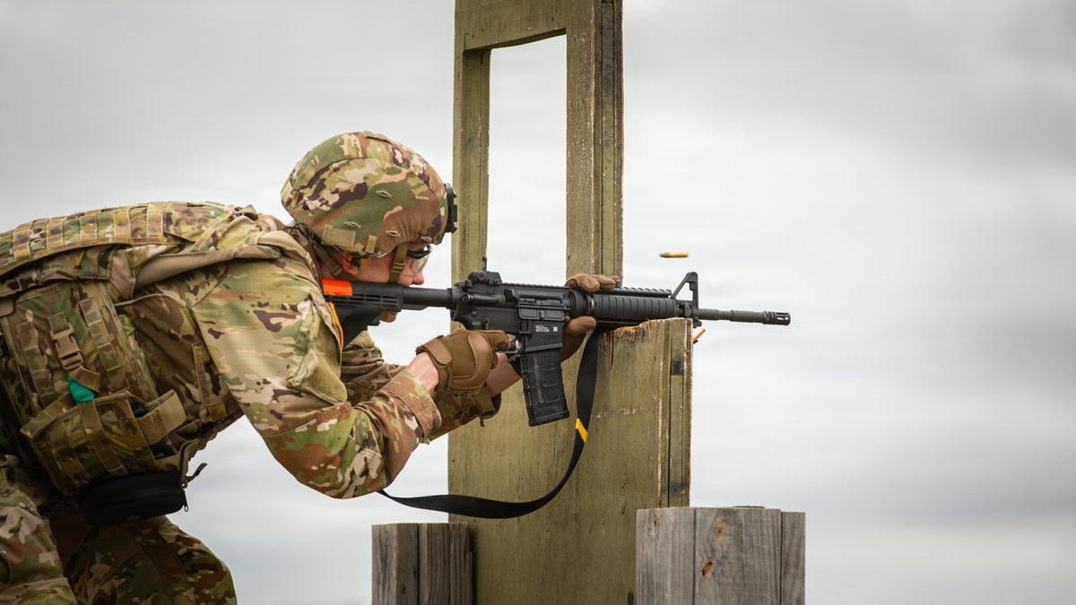 A U.S. Army soldier fires an M4 carbine in 5.56x45mm at a live-fire qualification range
