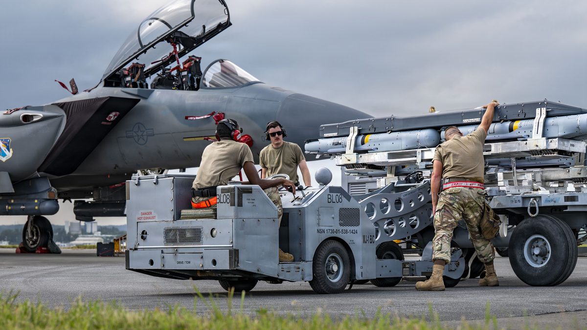 Airmen prepare to load munitions onto a US Air Force F-15EX Eagle II at Kadena Air Base, Japan