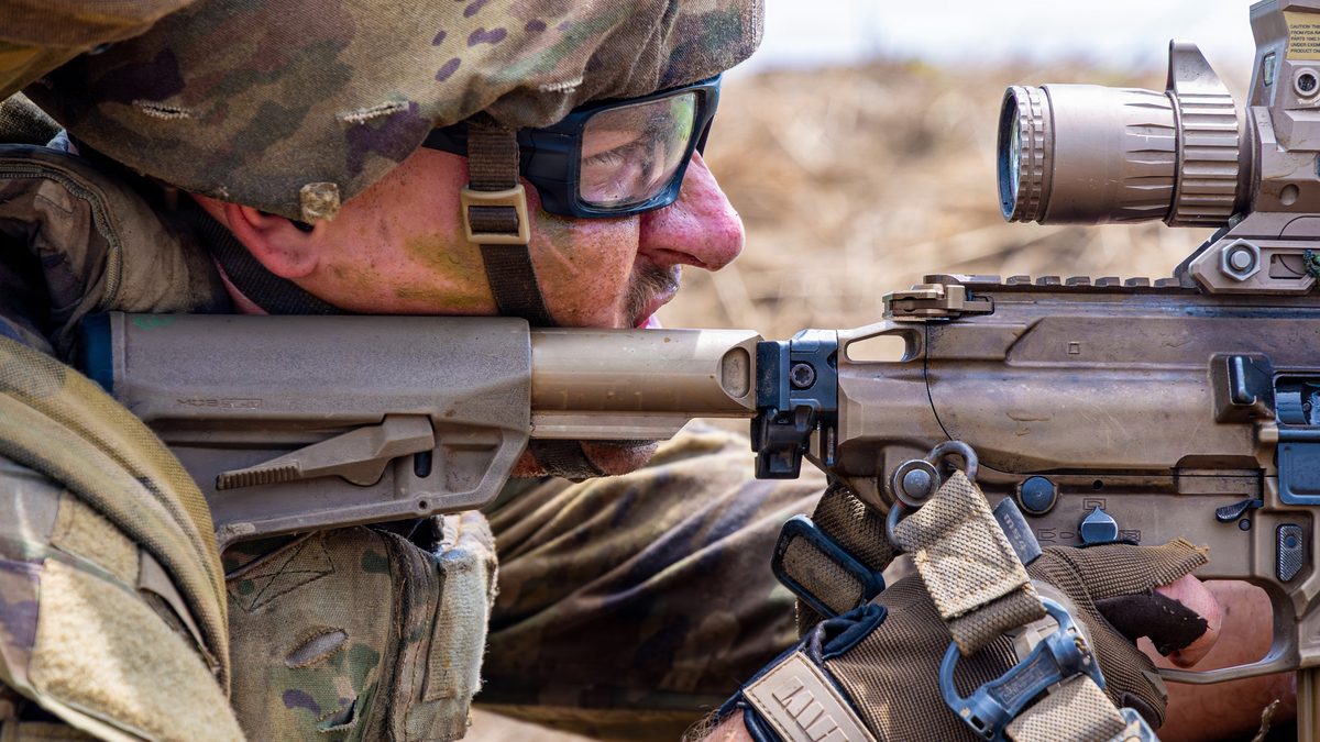 A US soldier sights through the optic of an M7 rifle during squad live fire training in the Philippines.