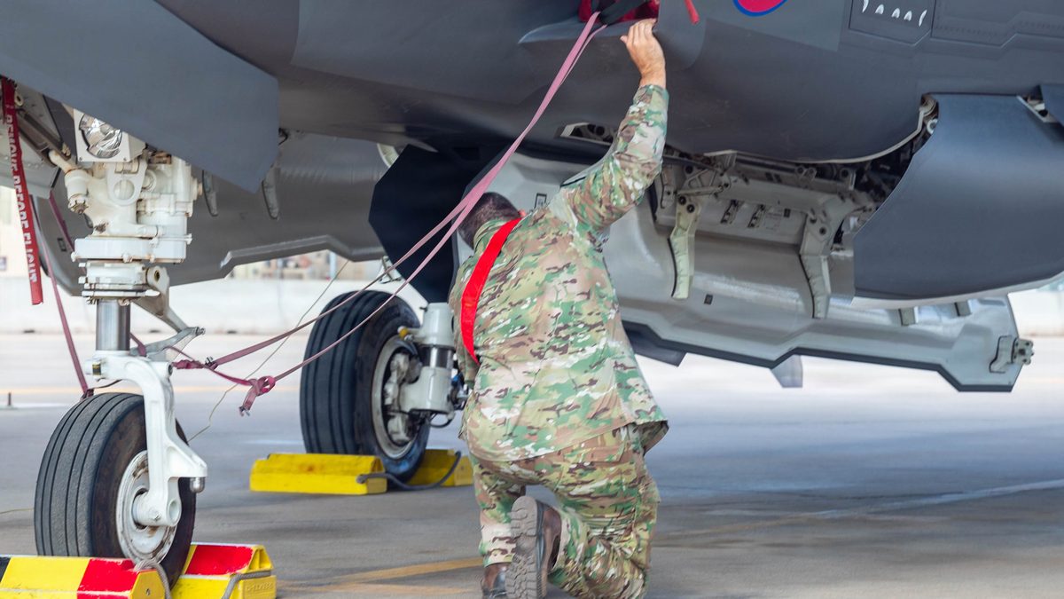 Belgian Air Force service member inspecting the open weapons bay of an F-35A Lightning II at Luke Air Force Base, Arizona