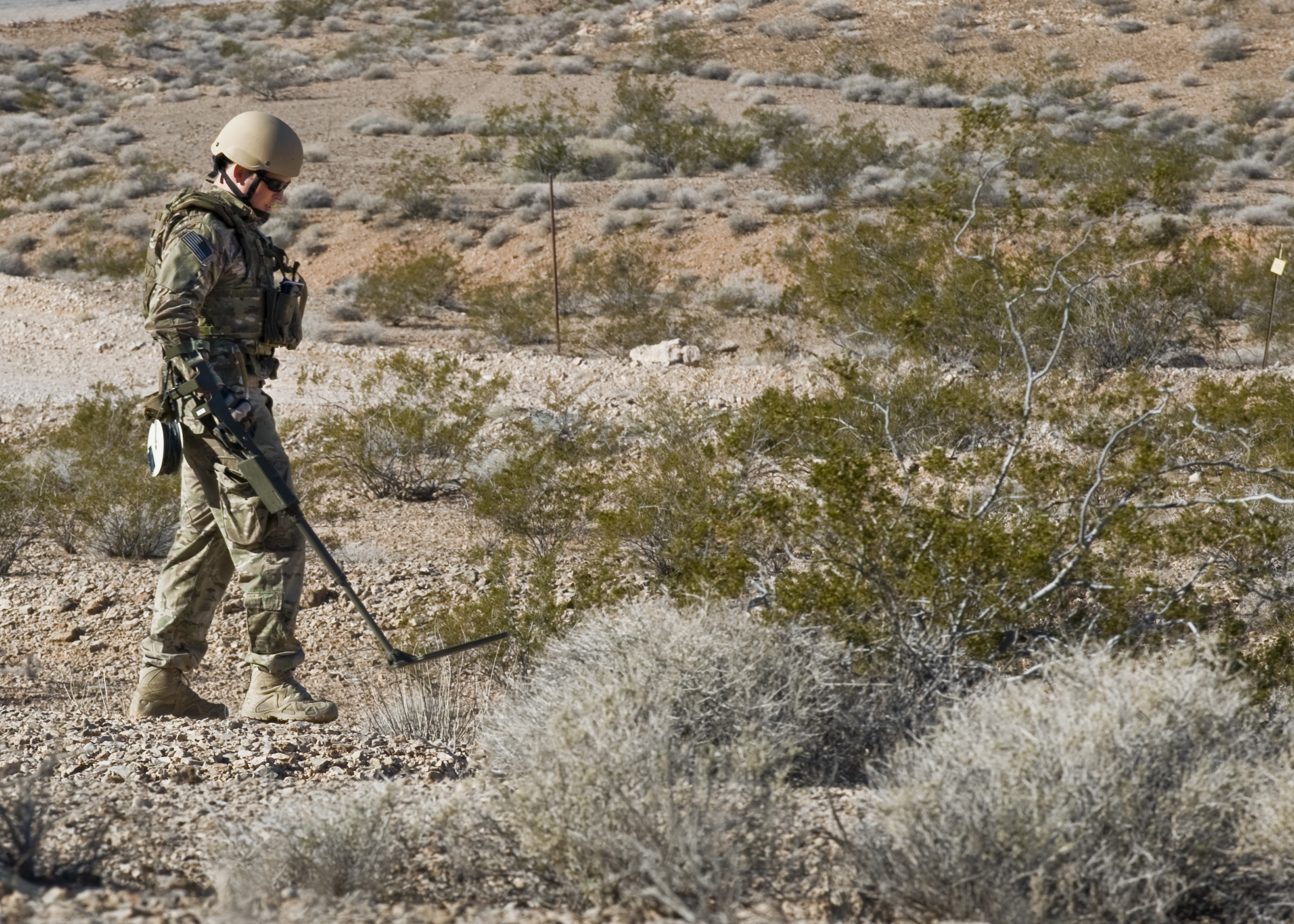 EOD specialist using metal detector during counter-IED training exercise